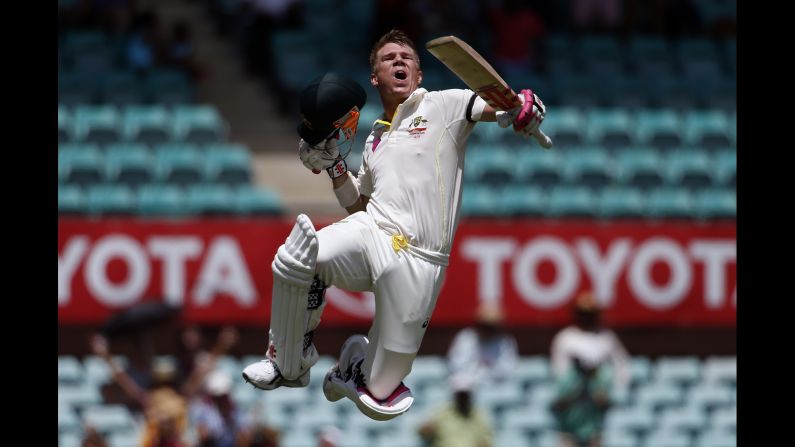 Australian cricket player David Warner celebrates a century while playing India in a Test match Tuesday, January 6, in Sydney. The match ended in a draw, but Australia won two matches earlier in the series.