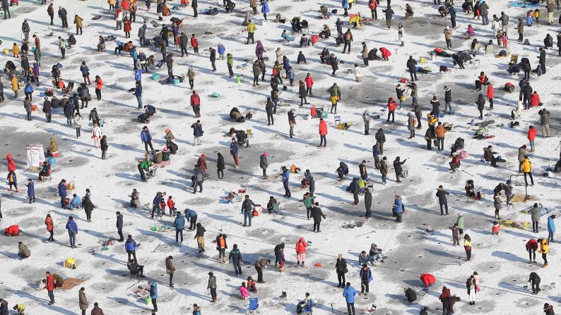 Anglers in Hwacheon-gun, South Korea, cast their lines through a frozen river during the Mountain Trout Ice Festival on Saturday, January 10. 