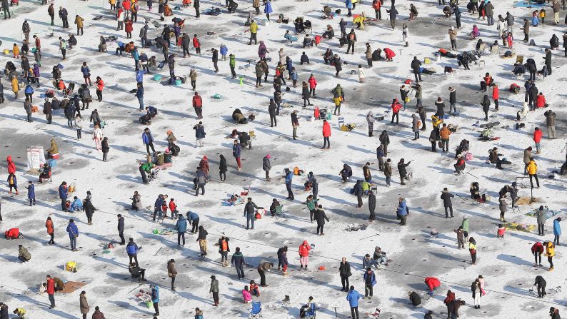 Anglers in Hwacheon-gun, South Korea, cast their lines through a frozen river during the Mountain Trout Ice Festival on Saturday, January 10.