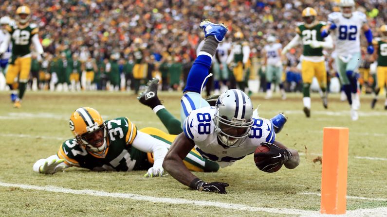 Dallas Cowboys wide receiver Dez Bryant tries to haul in a pass during a playoff game in Green Bay, Wisconsin, on Sunday, January 11. The fourth-down pass was initially ruled a catch before it was reversed by the officials after a video review. Green Bay was then able to salt away the last few minutes of the clock to win 26-21.