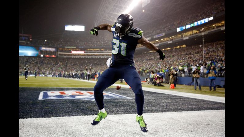 Seattle Seahawks safety Kam Chancellor celebrates after he returned an interception for a touchdown during a home playoff game against Carolina on Saturday, January 10. The Seahawks, the defending NFL champions, advanced to the conference title game with a 31-17 victory.