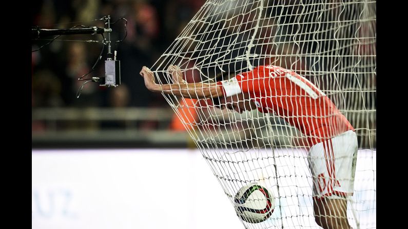 Benfica midfielder Nicolas Gaitan celebrates inside the net after scoring a goal against Vitoria during a league match in Lisbon, Portugal, on Saturday, January 10. Benfica won 3-0 to stay in first place by six points.