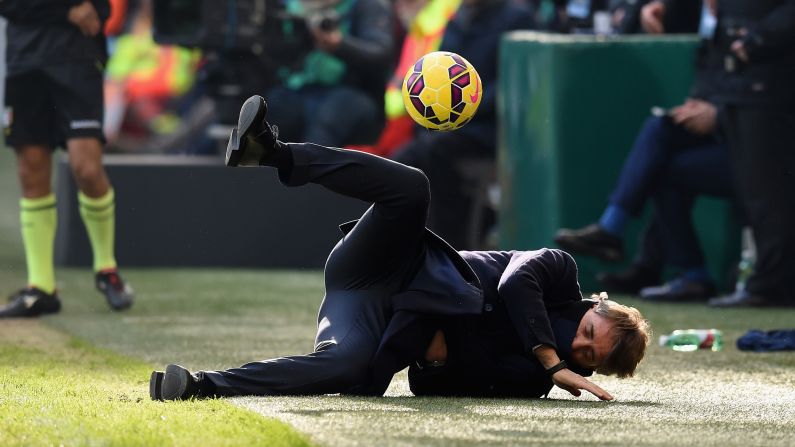 Inter Milan head coach Roberto Mancini falls to the ground after he was inadvertently hit in the face by a ball during an Italian league match on Sunday, January 11. Mancini laughed off the blow, which came from the boot of one of his own players.