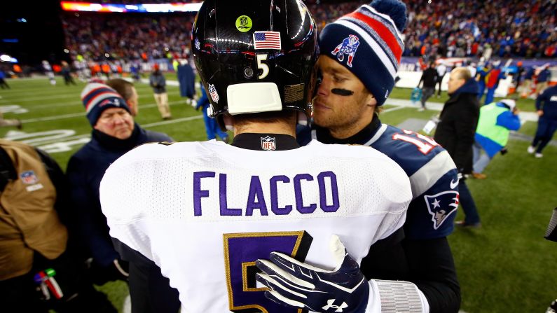 New England Patriots quarterback Tom Brady embraces Baltimore Ravens quarterback Joe Flacco on Saturday, January 10, after the Patriots defeated the Ravens 35-31 in Foxborough, Massachusetts.