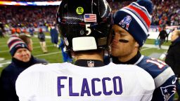 Joe Flacco #5 of the Baltimore Ravens and  Tom Brady #12 of the New England Patriots hug following the 2015 AFC Divisional Playoffs game at Gillette Stadium on January 10, 2015 in Foxboro, Massachusetts.