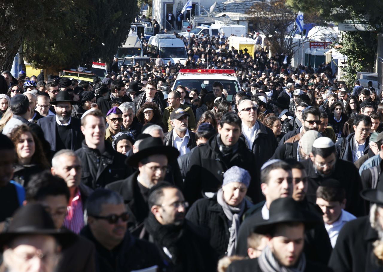 The funeral procession takes place on a Jerusalem street.
