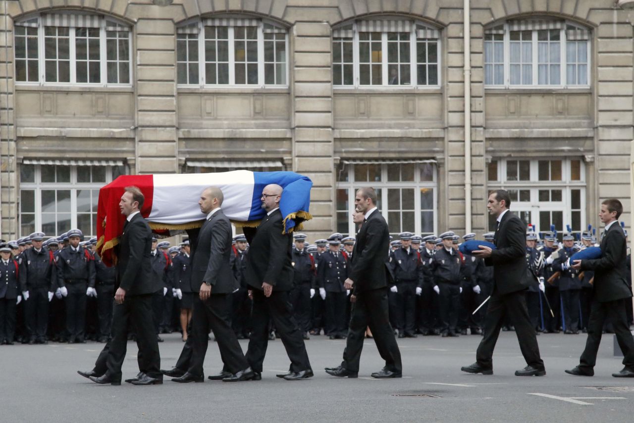 French police officers carry Brinsolaro's coffin. He was a protection officer for Charlie Hebdo's editor, Stephane Charbonnier.