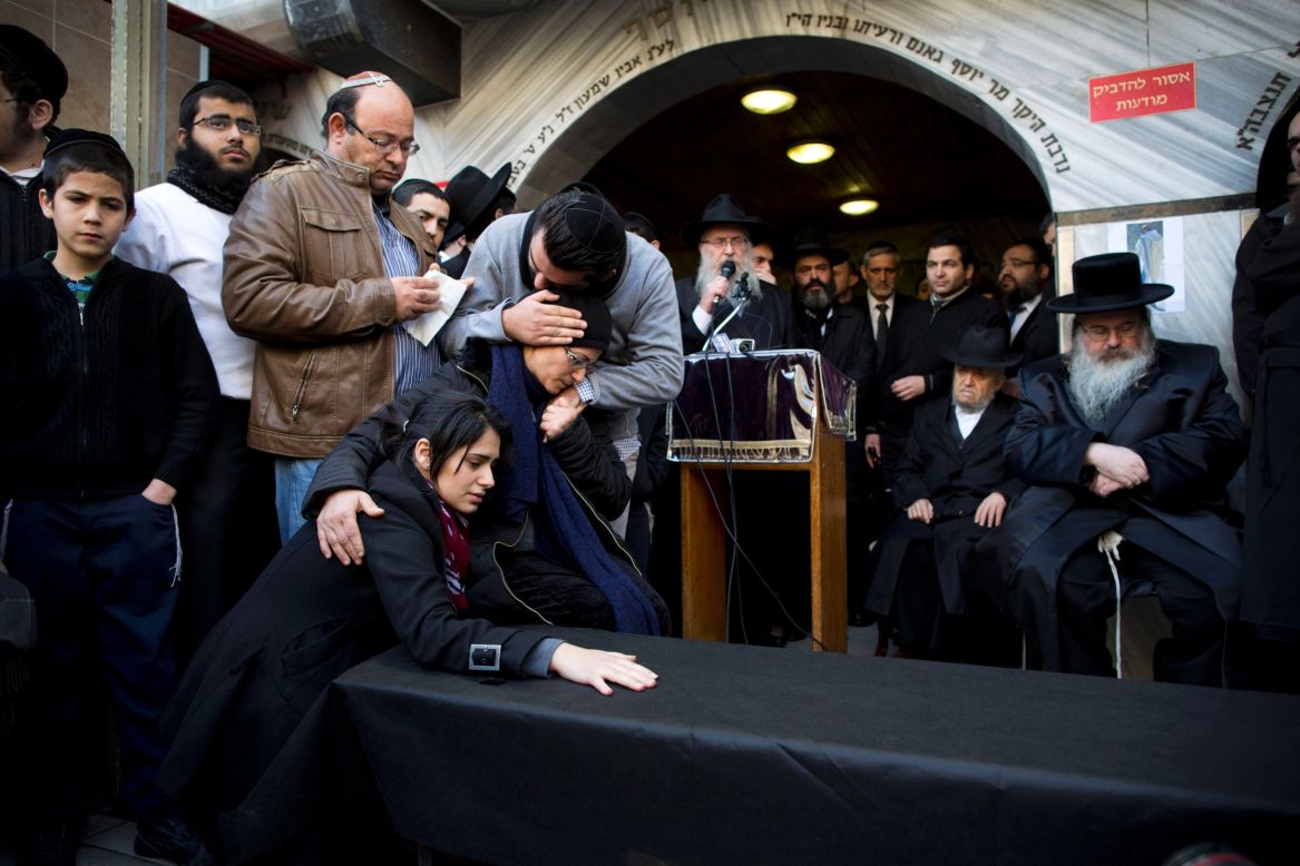 The family of Hattab gather around a symbolic coffin for his funeral procession in the city of Bnei Brak near Tel Aviv. 