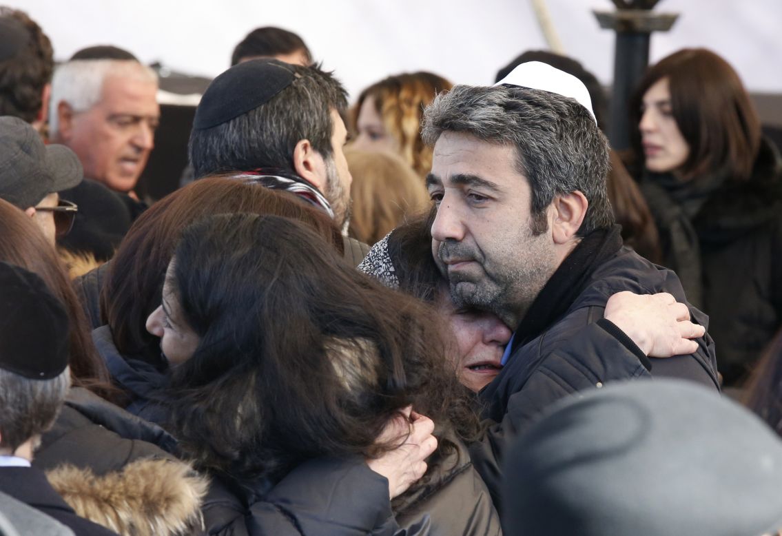 Israeli mourners hug at the funeral in Jerusalem on January 13, 2015 of four French Jews, Philippe Braham, Yohan Cohen, Yoav Hattab and François-Michel Saada, killed in an attack on a kosher supermarket in Paris last week. 