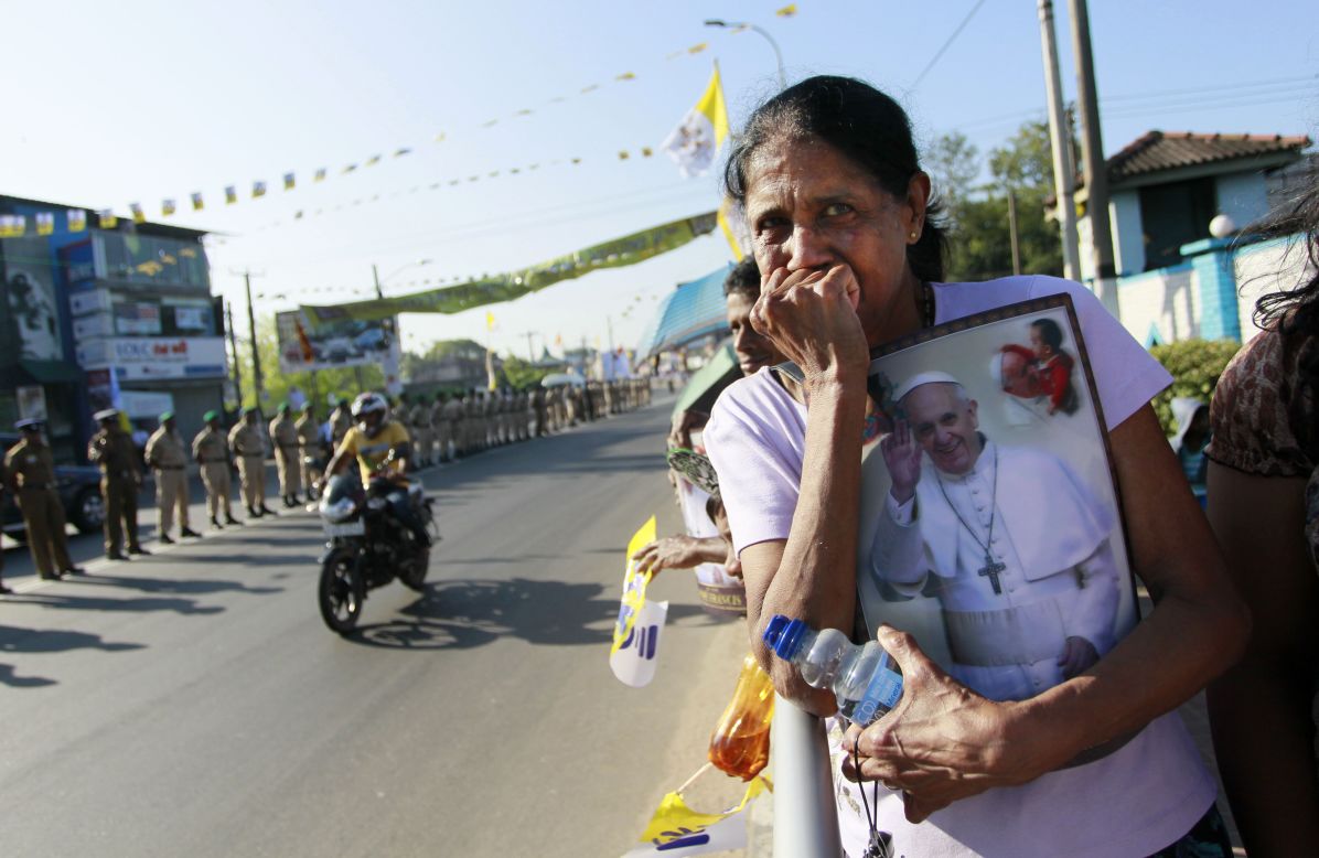 A Sri Lankan Catholic holds a portrait of Pope Francis and awaits his arrival, on the outskirts of Colombo, Sri Lanka, on January 13.