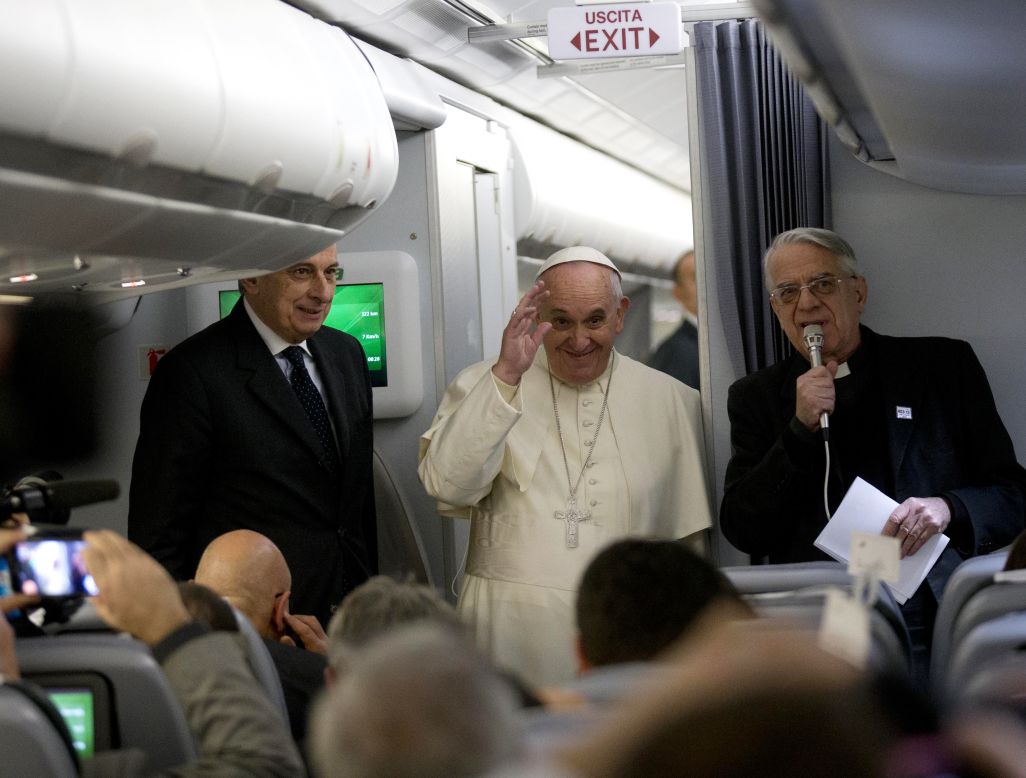 Pope Francis salutes reporters during his flight to Colombo, Sri Lanka on January 12.