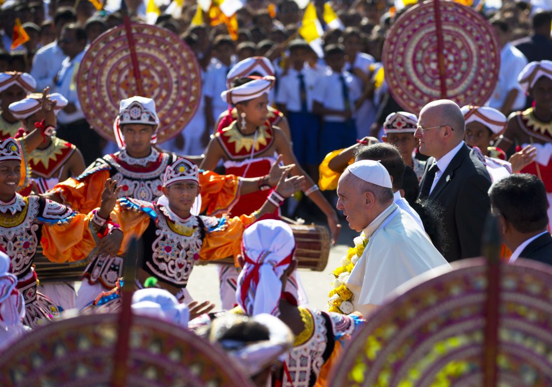 JANUARY 13 - COLOMBO, SRI LANKA: Pope Francis walks past colorful dancers upon his arrival in Colombo. This is the first leg of the pontiff's week-long trip to Asia, where he was received at the airport by <a href="http://cnn.com/2015/01/08/asia/sri-lanka-elections-walkup/">newly-elected President Maithripala Sirisena</a> and Cardinal Malcolm Ranjith.