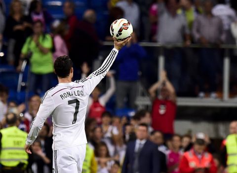 September 24: Ronaldo takes the game ball after his third hat trick of the 2014-15 season, against Bilbao.
