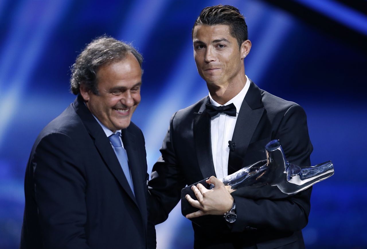 August 28: Ronaldo is congratulated by UEFA head Michel Platini as he wins the UEFA European Player of the Year trophy.