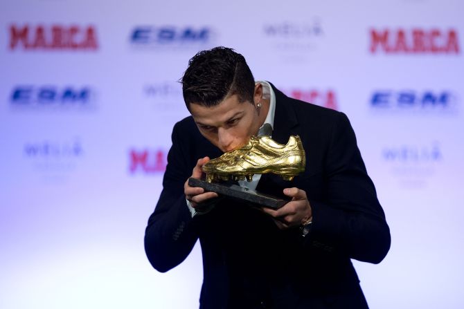 November 5: Ronaldo kisses his Golden Boot 2014 award at Melia Castilla hotel in Madrid, Spain. His 31 strikes in La Liga last season earned him his third Golden Boot.