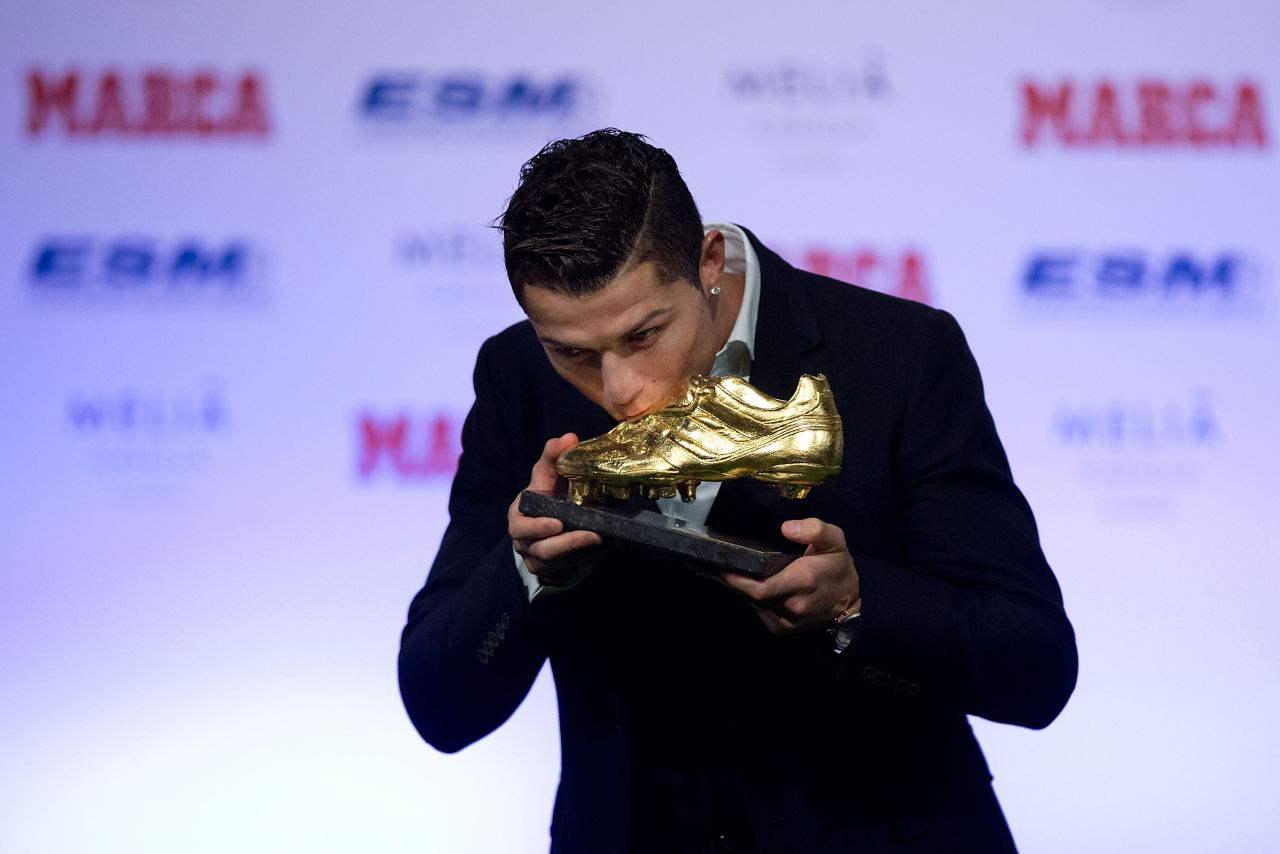 November 5: Ronaldo kisses his Golden Boot 2014 award at Melia Castilla hotel in Madrid, Spain. His 31 strikes in La Liga last season earned him his third Golden Boot.