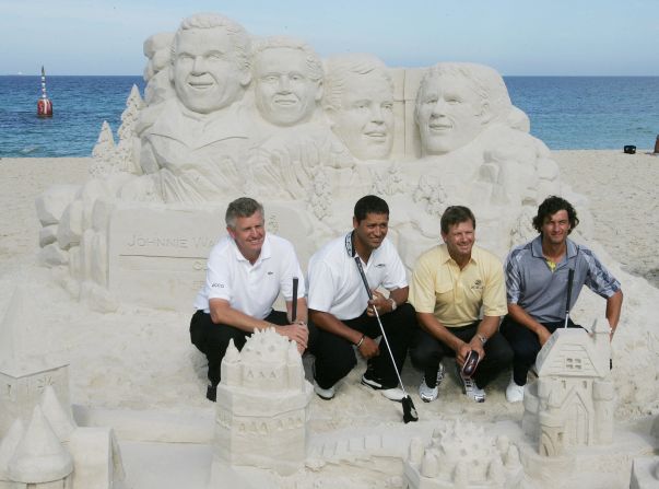 Colin Montgomerie, Michael Campbell, Retief Goosen and Adam Scott line up in front of sand sculptures of themselves at Cottesloe Beach, Australia, before the 2006 Johnnie Walker Classic.