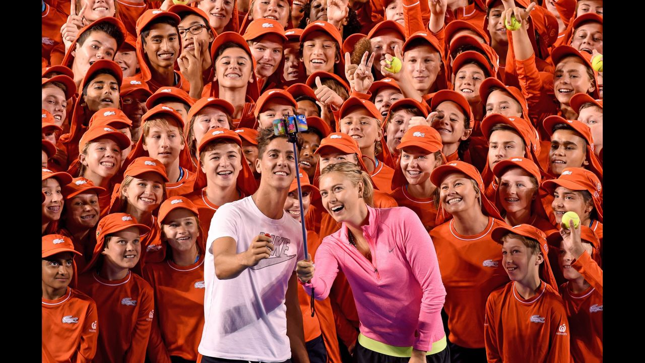 Pro tennis players Maria Sharapova and Thanasi Kokkinakis take a selfie with ball boys (and girls) at Melbourne's Rod Laver Arena on Tuesday, January 13.