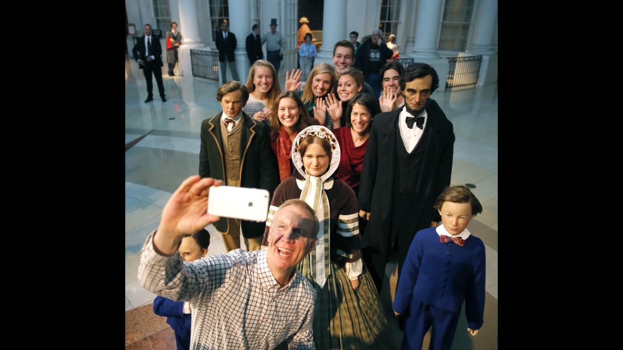 Bruce Rauner, Illinois's governor-elect, takes a selfie Sunday, January 11, with his family and some statues at the Abraham Lincoln Museum in Springfield, Illinois. He was inaugurated a day later.