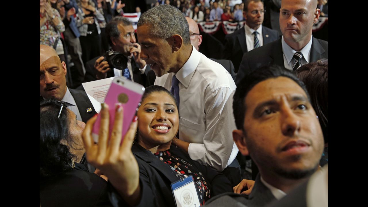 A young woman in Phoenix holds up her phone to get a selfie with U.S. President Barack Obama on Thursday, January 8. Obama had just given a speech about the housing market.