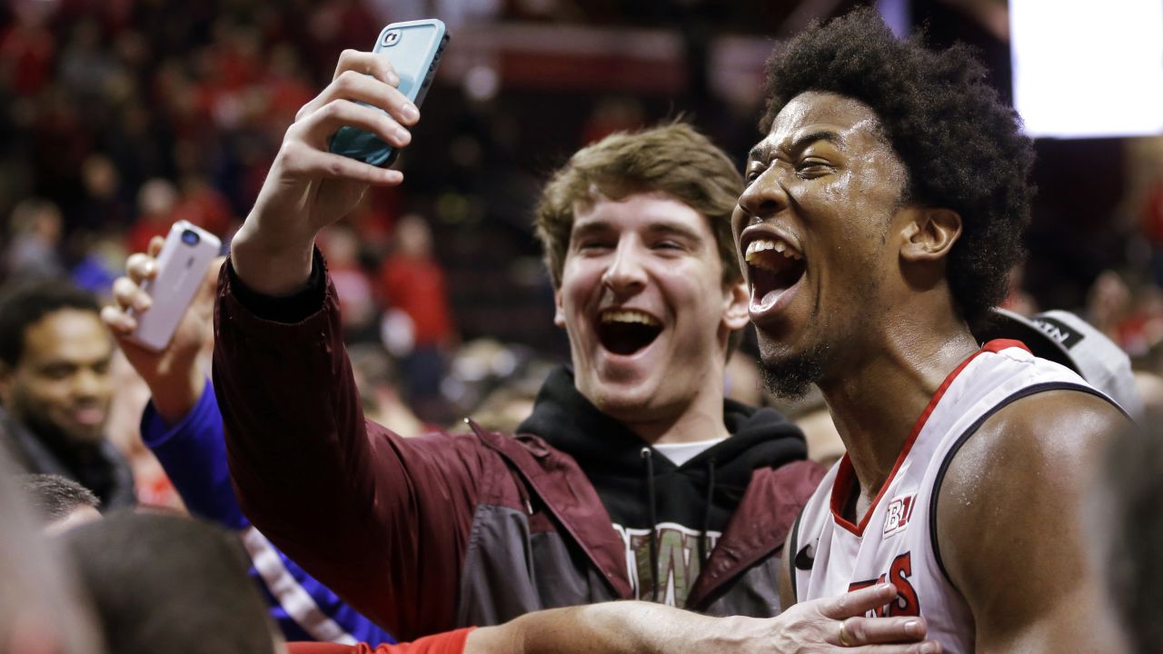 A fan gets a selfie with Rutgers basketball player Kadeem Jack on Sunday, January 11, after Rutgers defeated Wisconsin in Piscataway, New Jersey.