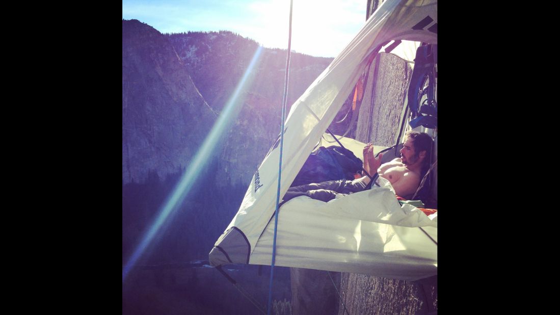 Jorgeson looks at his hands during a break in the climb. 