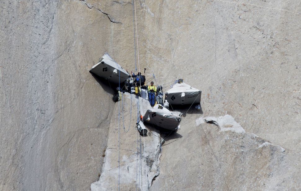 Caldwell, in yellow, stands with a photographer at a base camp before continuing to climb on January 12. Caldwell and Jorgeson had ropes designed to catch them if they fell. 