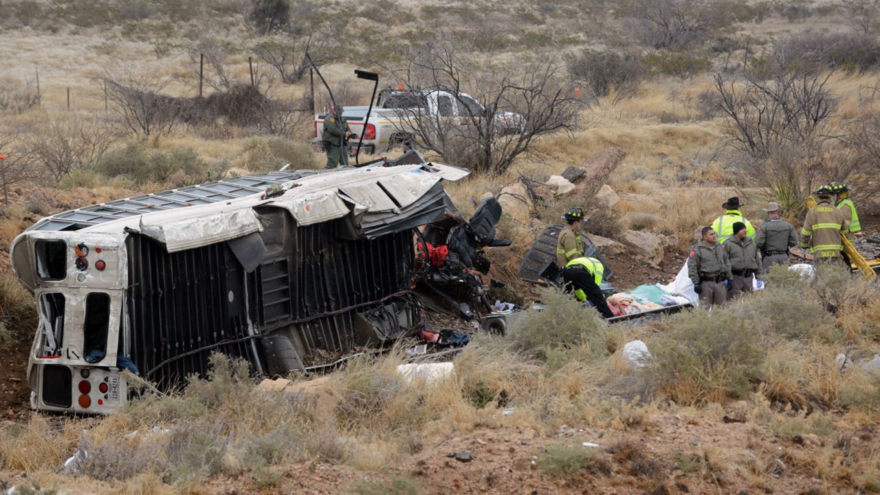 Officials investigate the scene of  the bus-train collision in Penwell, Texas.