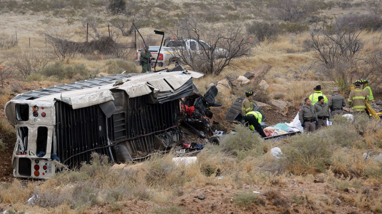 Officials investigate the scene of the bus-train collision in Penwell, Texas.