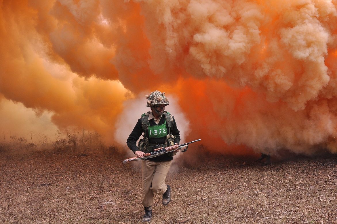 JANUARY 14 - HOSHIARPUR, INDIA: An Indian Border Security Force (BSF) female commando runs from thick smoke during an exercise at the Kharkan Training Camp, around 60 kms from Jalandhar. The BSF is a paramilitary force charged with guarding India's land border in peacetime and preventing transnational crime. 