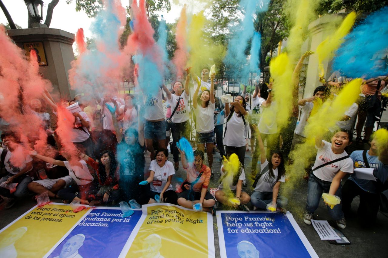 Youth and students throw colored powder in the air at the start of the countdown to welcome Pope Francis, on January 14 in Manila, Philippines.