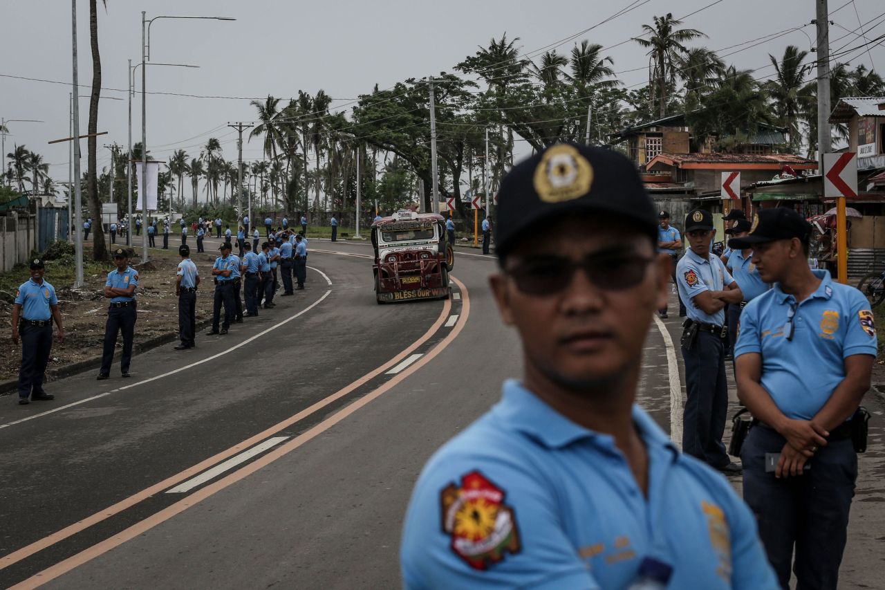 Police line a road in Tacloban, Leyte as they rehearse security procedures ahead of the visit of Pope Francis on January 14.