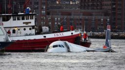 NEW YORK - JANUARY 15:  A New York City Fire Department boat floats next to a US Airways plane floating in the water after crashing into the Hudson River in the afternoon on January 15, 2009 in New York City. The Airbus 320 flight 1549 crashed shortly after take-off from LaGuardia Airport heading to Charlotte, North Carolina.   (Photo by Jerritt Clark/Getty Images)