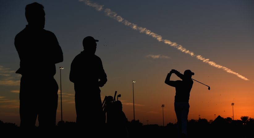 McIlroy practices under the watchful eyes of his connections ahead of his opening round of the year in Abu Dhabi. 