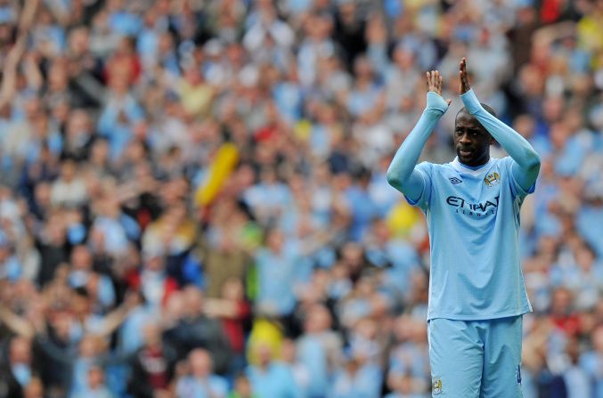 Toure applauds the Manchester City support as the club finally end their wait for the Premier League title in the most dramatic of circumstances, courtesy of Sergio Aguero's late goal to defeat QPR 3-2 in the final seconds of the 2011-12 season.