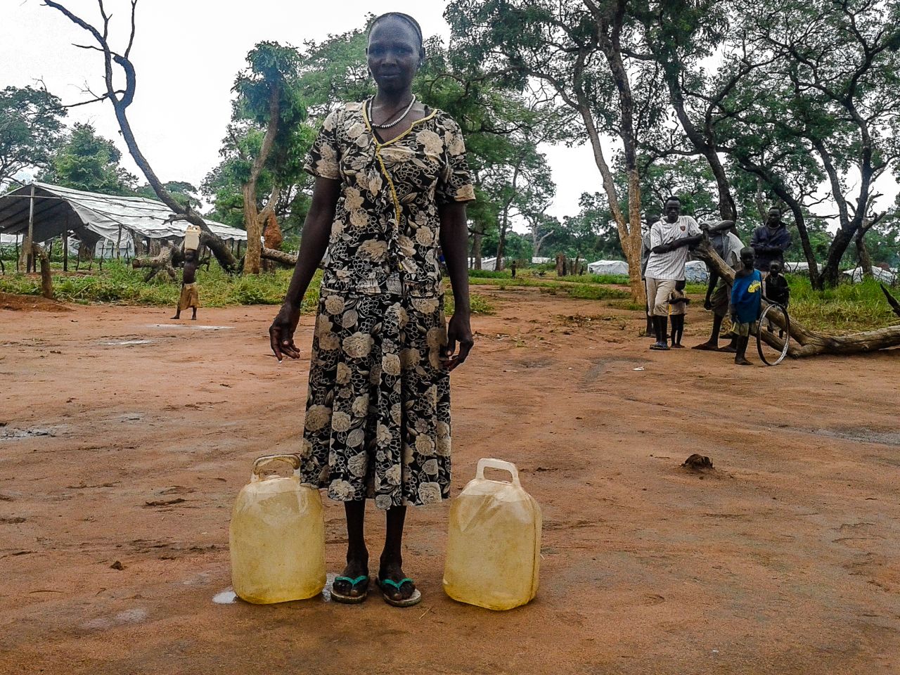 <br />"She brought water from a distance, until she was tired. That is why she is resting. Water is fetched for cooking and keeping homes clean. But the problem is that people need bigger jerry cans, these small ones don't help much."