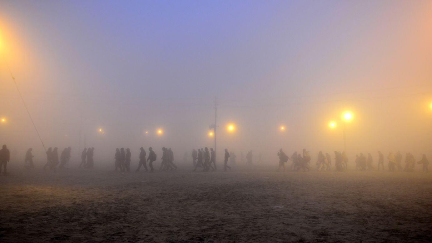 JANUARY 15 - ALLAHABAD, INDIA: Indian Hindu devotees arrive during a cold and foggy morning to take a holy dip for the Makar Sankranti festival. The annual Magh Mela gathering takes place at Sangam, the confluence of the rivers Ganges, Yamuna and the legendary Saraswati.