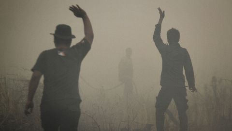 Indonesian firefighters put out a fire on smoldering peatland in Siak Regency located in Riau province on Indonesia's Sumatra island, March 1, 2014.