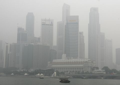 Singapore's skyscrapers enveloped in smog, 16 October 2006, from forests fire in Indonesia. The annual recurrence of carbon-rich haze caused by fires in Indonesia's vast tropical peatlands may help fuel global warming if left unchecked, experts have warned.