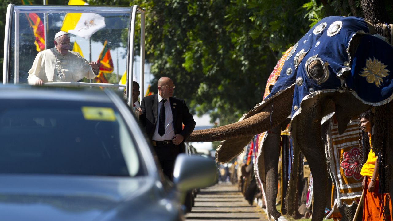 Pope Francis waves as he passes a row of decorated elephants in Colombo, Sri Lanka, on Tuesday, January 13. It was the first stop on <a href="http://www.cnn.com/2015/01/13/world/gallery/pope-in-asia/index.html" target="_blank">his weeklong trip to Asia.</a>