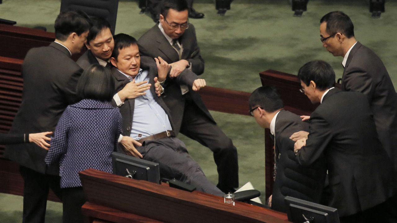 Pro-democracy legislator Raymond Chan is taken away by security guards after he protested against Hong Kong Chief Executive Leung Chun-ying during Leung's annual policy address on Wednesday, January 14.