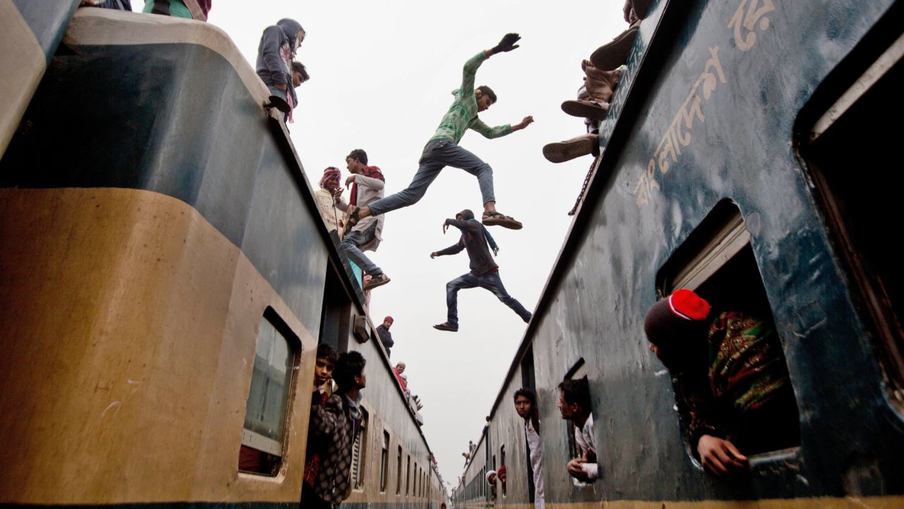 Boys in Tongi, Bangladesh, jump from one overcrowded train to another on Sunday, January 11. Thousands of Bangladeshi Muslims were trying to return home after attending the Islamic Congregation, a three-day religious gathering.