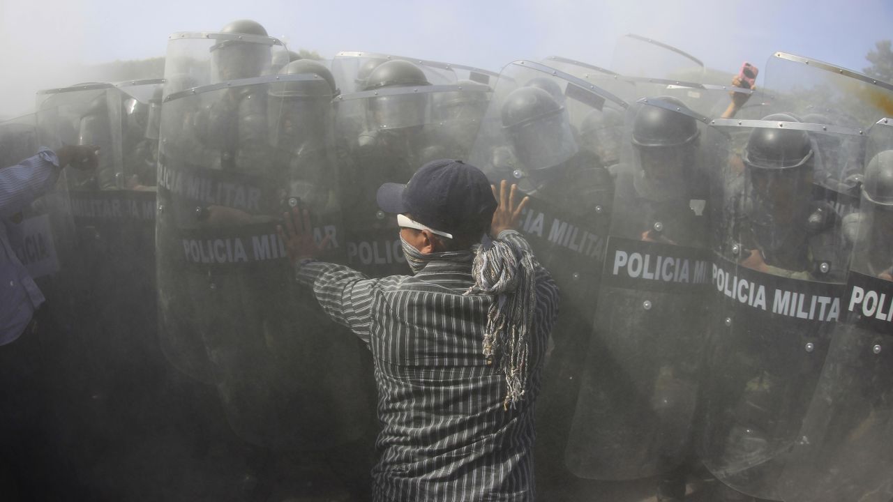 A relative of one of <a href="http://www.cnn.com/2014/11/14/world/americas/mexico-missing-students-vignettes/" target="_blank">the 43 Mexican students who went missing from a teacher's college</a> confronts military police officers during a demonstration in Iguala, Mexico, on Monday, January 12.