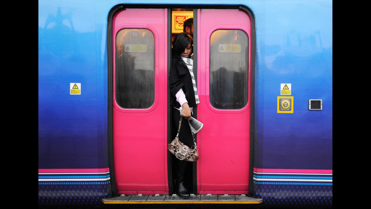 A commuter struggles to get on a crowded train during a bus strike in London on Tuesday, January 13.