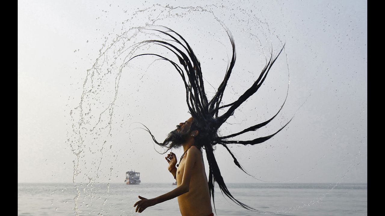 A Hindu holy man takes a dip at the confluence of the Ganges river and the Bay of Bengal on Tuesday, January 13. Hindu monks and pilgrims were making their annual trip to Sagar Island, India, for the Makar Sankranti festival.