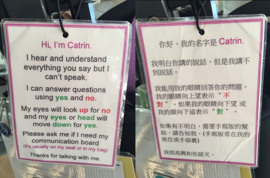 Catrin Anderson has cerebral palsy and carries a sign on her wheelchair telling people she can understand them.