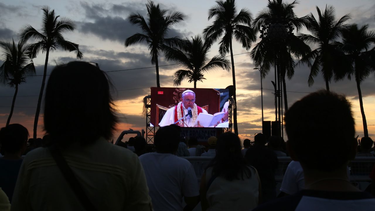 Crowds watch a live broadcast of Pope Francis during Mass on Friday, January 16,  in Manila, Philippines.