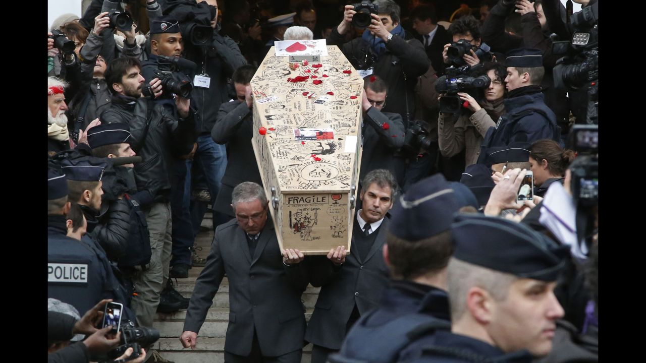Pallbearers carry the casket of Bernard Verlhac, a cartoonist known as Tignous, at the city hall of Montreuil, France, on Thursday, January 15.