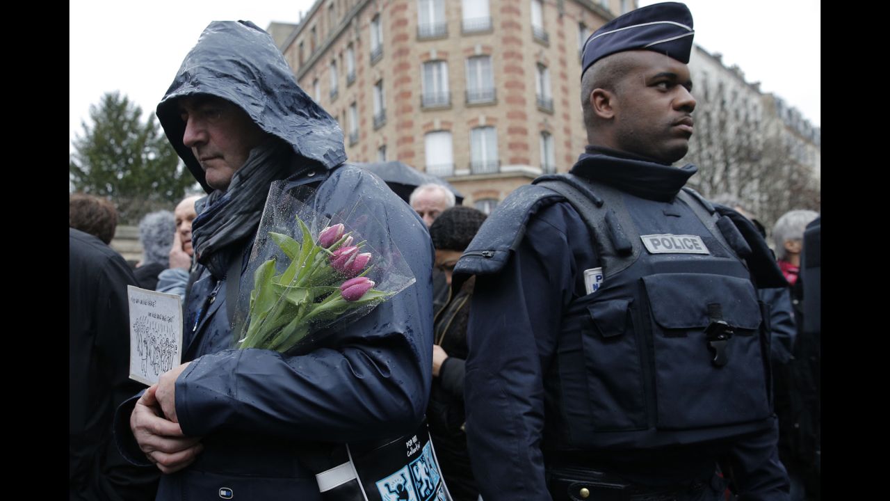 A man waits to enter the Pere Lachaise cemetery in Paris during Verlhac's funeral on January 15.