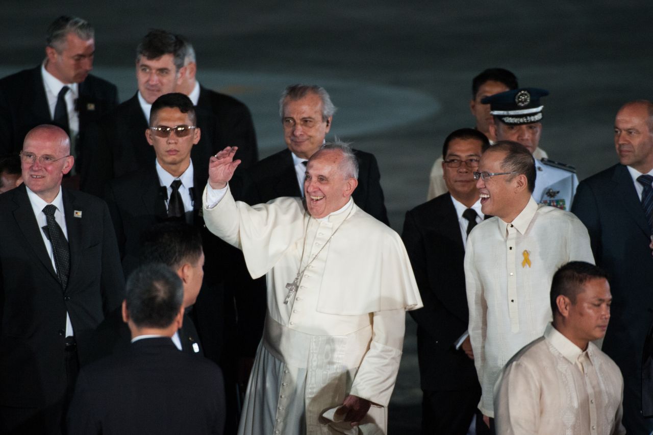 Pope Francis waves to the crowd with Philippine President Benigno Aquino upon his arrival in the Philippines on January 15 in Manila, Philippines.